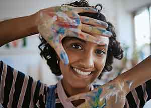 Student with paint on hands