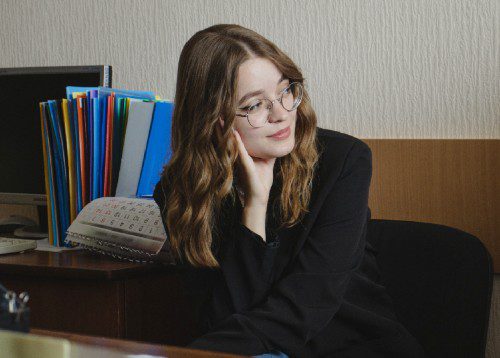 Young pensive woman on sofa