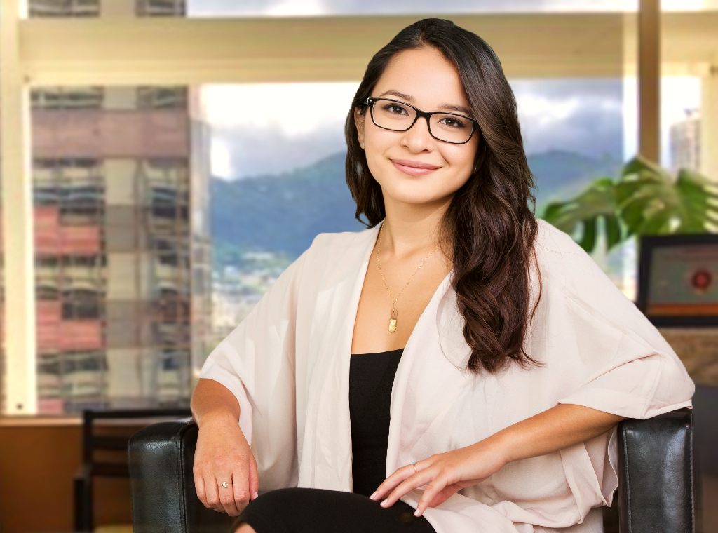 Young Asian woman with glasses in an office.