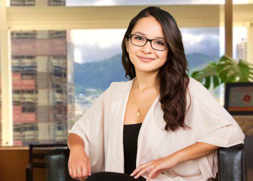 Young Asian woman with glasses in an office.