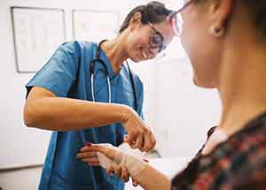 Medical assistant applying bandages