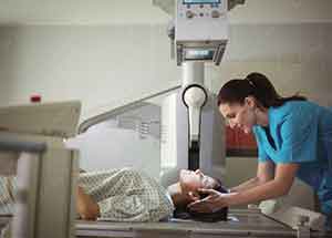 Radiologic technician preparing patient for xray